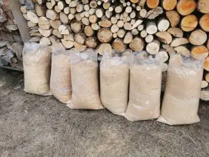 Packed sawdust bags for sale at BBS Sawmill – premium wood sawdust for poultry bedding, biomass fuel, gardening, and industrial use in Nepal.
